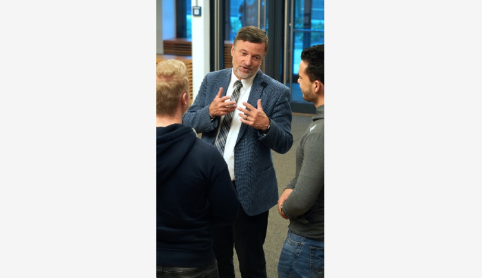 Photo of Professor talking to students